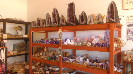Photo of shelves full of crystals, colourful rocks, and more